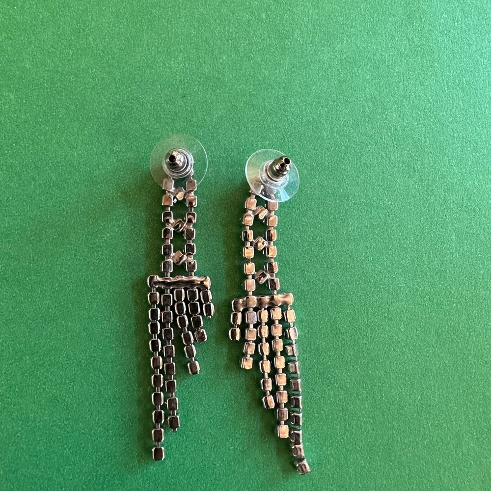 Glamorous 2 1/2” silver-tone rhinestone earrings with protective earring backs. - Picture 2 of 2